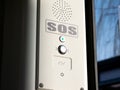 SOS signal button inside the tram, train, emergency help system push button, Braille inscription, detail. Public transport safety Royalty Free Stock Photo