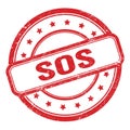 SOS text on red grungy vintage round stamp Royalty Free Stock Photo