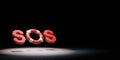 SOS Text Lifebelt Spotlighted on Black Background 3D Illustration