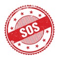 SOS text written on red grungy round stamp Royalty Free Stock Photo