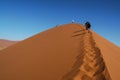 Sossusvlei, Namibia - tourists climbing a large sand dune in the early 2000s