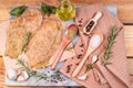 Sottilissime in marinade on a stone kitchen board with a branch of razmarin, olive oil, garlic and wooden spoons with salt and Royalty Free Stock Photo