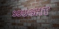 SOUGHT - Glowing Neon Sign on stonework wall - 3D rendered royalty free stock illustration