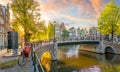 Soul of Amsterdam. Early morning in Amsterdam. Ancient houses, bridges, traditional bicycles, canals and the sun shines through Royalty Free Stock Photo