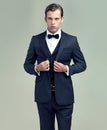 A soul of the 1950s. A studio portrait of a dapper young man wearing a vintage suit and bow tie.