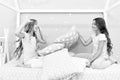 Soulmates girls having fun sleepover party. Girls happy friends with cute pillows. Pillow fight pajama party. Sleepover