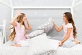 Soulmates girls having fun sleepover party. Girls happy friends with cute pillows. Pillow fight pajama party. Sleepover