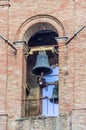 Ancient bell tower with bells and flag of the historic city Royalty Free Stock Photo