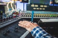 Sound editor engineer working at studio with mixing panel, mixing music and sound, stage sound mixer, boutique recording studio, Royalty Free Stock Photo