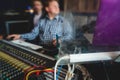 Sound editor engineer working at studio with mixing panel, mixing music and sound, stage sound mixer, boutique recording studio, Royalty Free Stock Photo