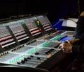 Sound engineer controls the settings of mixing console Royalty Free Stock Photo