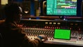 Sound engineer expert recording audio tracks next to tablet mockup
