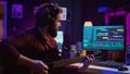 Sound engineer playing acoustic guitar and using mixing console to record music