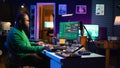 Sound engineer pressing keys of electronic synthesizer and composing new song