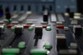 Sound engineer`s mixing console, close-up of faders and sliders, selective focus, toning.