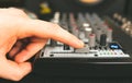 Sound engineer using main control fader Royalty Free Stock Photo