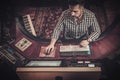 Sound engineer working at mixing panel in the boutique recording studio. Royalty Free Stock Photo