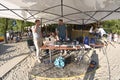 Sound engineers standing near sound mixer table set with equipment during fest of Yoga and Vedic Culture