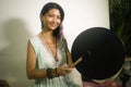 Sound healing and meditation therapy - attractive and elegant Asian Chinese healer woman playing drum at yoga studio as relaxation