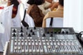 A sound mixer control panel with some people in the background wedding concepts Royalty Free Stock Photo