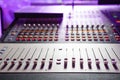 Sound mixer. Professional audio mixing console with lights, buttons, faders and sliders. Royalty Free Stock Photo