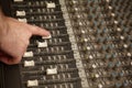 Sound producer moving fader of dusty sound mixer Royalty Free Stock Photo