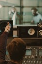 sound producer showing thumb up to singers behind glass