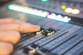 Sound recording studio mixer desk: sound engineer is operating a professional music production Royalty Free Stock Photo