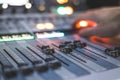 Sound recording studio mixer desk: sound engineer is operating a professional music production Royalty Free Stock Photo