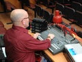 The sound technician works on the mixing console