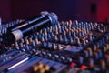 Soundman working on the mixing console in concert hall. Royalty Free Stock Photo