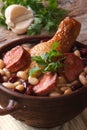 Soup with beans, chicken legs and sausages close up vertical Royalty Free Stock Photo