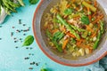 Soup with beef, asparagus, green peas, carrots and celery.