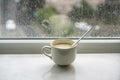 Soup in a bowl on windowsill in a rainy day