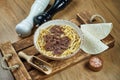 Soup on the broth with noodles and stewed beef in a white ceramic plate on a wooden tray. Food flat lay Royalty Free Stock Photo