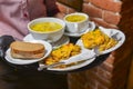 Soup and fried potetoes dinner. Waiter serving dinner at restaurant or diner, eating out concept