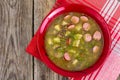 Soup of green lentils in a red ceramic bowl Royalty Free Stock Photo