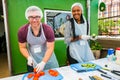 Soup Kitchen community outreach volunteers preparing meals for African children at orphanage Royalty Free Stock Photo