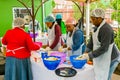 Soup Kitchen community outreach volunteers preparing meals for African children at orphanage Royalty Free Stock Photo