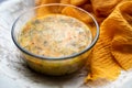 Soup kulesh with millet, potatoes and carrots in a clear bowl on an orange cloth.