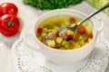 Soup with meat balls, potatoes and vegetables in a white plate on a white table Royalty Free Stock Photo