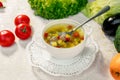 Soup with meat balls, potatoes and vegetables in a white plate on a white table Royalty Free Stock Photo