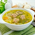 Soup with meatballs and noodles in bowl on napkin Royalty Free Stock Photo