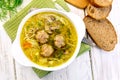 Soup with meatballs and noodles in bowl on napkin top Royalty Free Stock Photo