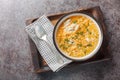 Soup with pastina pasta, chicken, vegetables and cheese close-up in a bowl on a wooden board. Horizontal top view Royalty Free Stock Photo