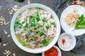 Soup Pho Bo on dark stone table. Vietnamese cuisine