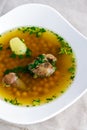 Soup piti with mutton and chickpeas in a white plate. Petey