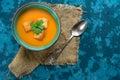 Soup pumpkin puree and small croutons on a blue background. Top view. Autumn menu concept. Copy space. Royalty Free Stock Photo