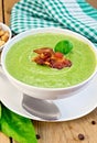 Soup puree with bacon and spoon on board Royalty Free Stock Photo