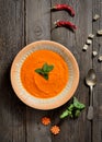 Soup puree of carrots,vintage spoon on a wooden background, top view